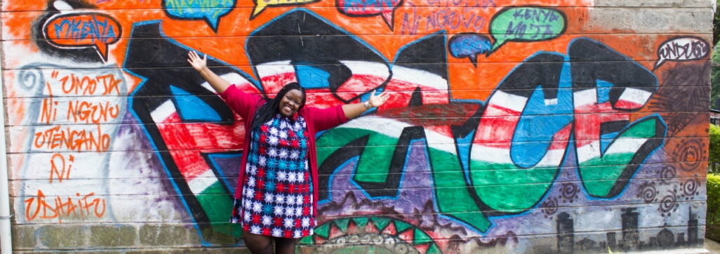 Michelle happy in front of graffiti wall